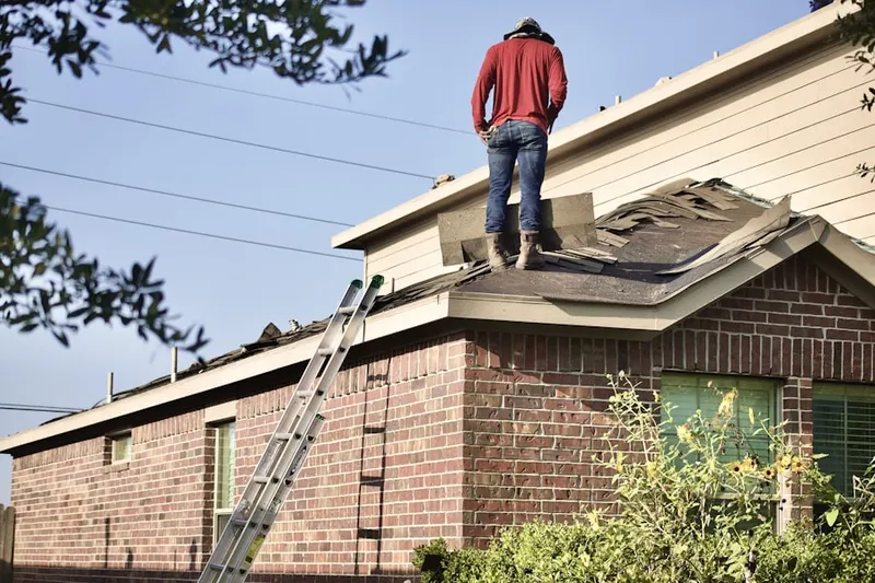 Professional roofer working on a residential roof in Bonita